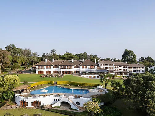 Fairmont Mount Kenya Safari Club colonial resort grounds with Mount Kenya backdrop